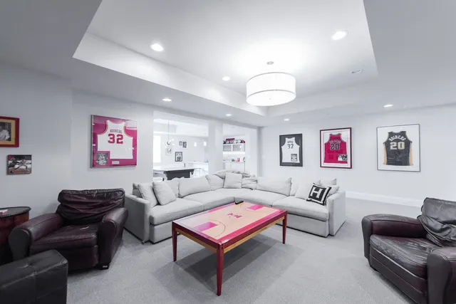 a living room with furniture a rug and a projector