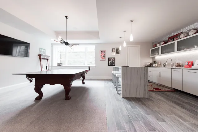a living room with furniture and kitchen view