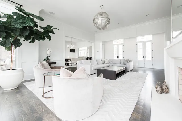 a living room with furniture potted plant and a chandelier