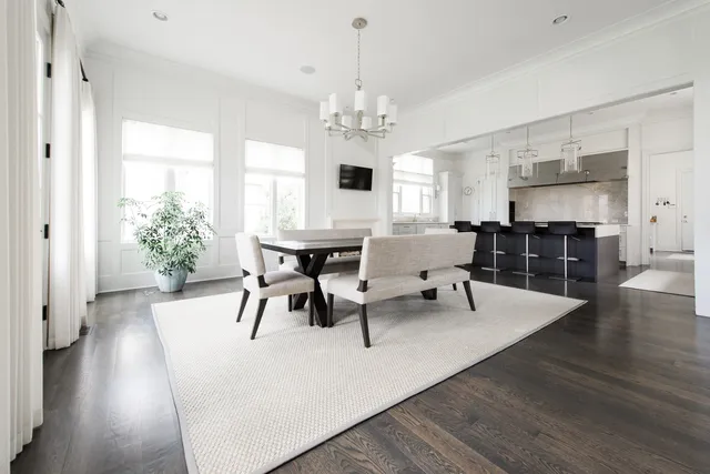 a living room with furniture dining table a chandelier and a fireplace