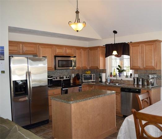 18 Barre Paxton Road Rutland, MA 01543 - Photo 7 of 17 a kitchen with stainless steel appliances a refrigerator a stove a sink a center island and chairs