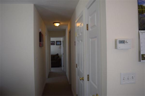 18 Barre Paxton Road Rutland, MA 01543 - Photo 8 of 17 a view of a hallway with wooden shelves