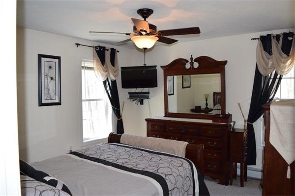 18 Barre Paxton Road Rutland, MA 01543 - Photo 9 of 17 a bedroom with a bed a flat screen tv and a window