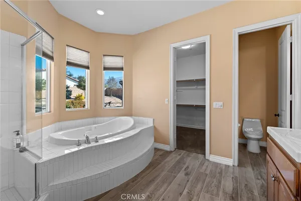 a spacious bathroom with a bathtub and a sink