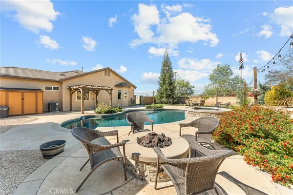 a view of a swimming pool with outdoor seating