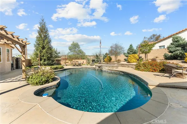 a view of a swimming pool with a yard