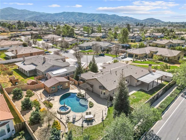 an aerial view of residential house with outdoor space and mountain view