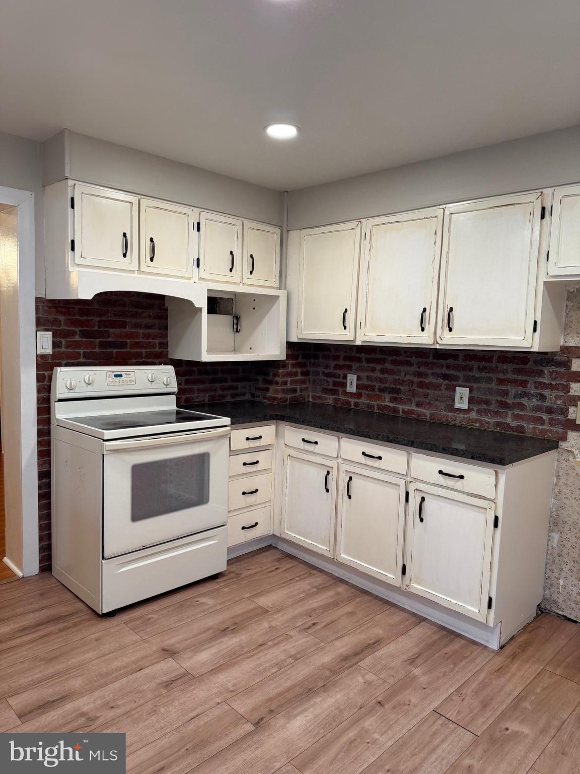85 Virginia Avenue Coatesville, PA 19320 - Photo 2 of 15 a kitchen with granite countertop white cabinets and white appliances