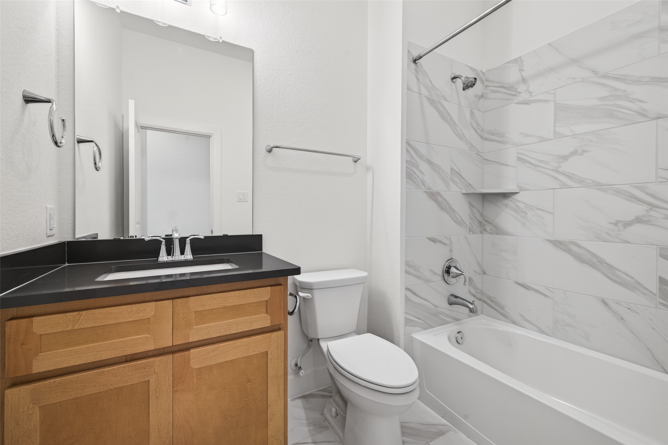 211 Amaranth Way Richmond, TX 77406 - Photo 10 of 26 a bathroom with a granite countertop sink a toilet and shower