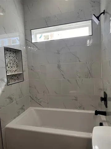 a bathroom with a bathtub and a toilet