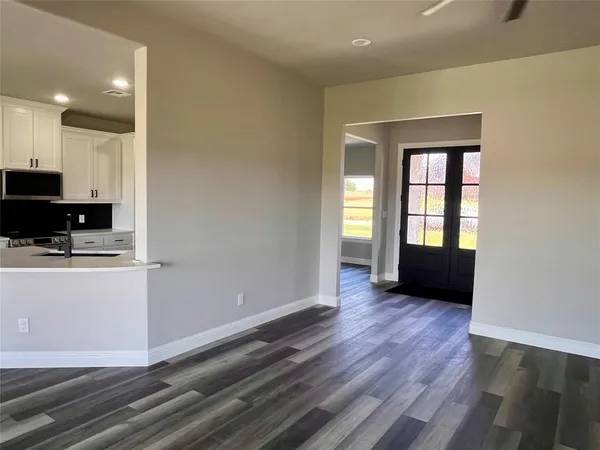 a view of kitchen with microwave and wooden floor