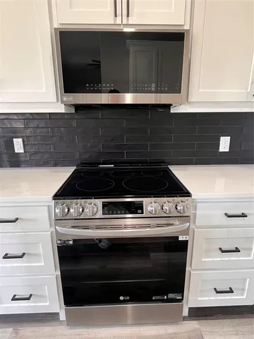 a stove top oven sitting inside of a kitchen
