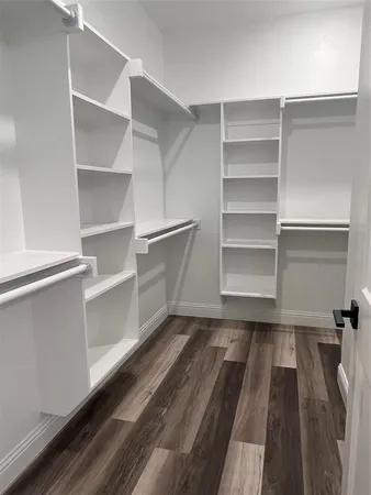 a view of walk in closet with empty racks