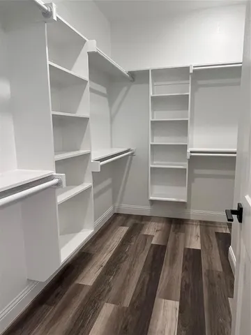 a view of walk in closet with empty racks