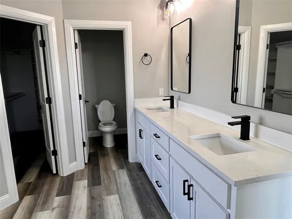 a spacious bathroom with a double vanity sink and a mirror