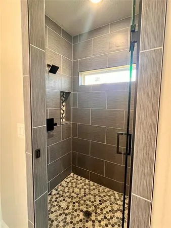 a bathroom with a shower and a sink