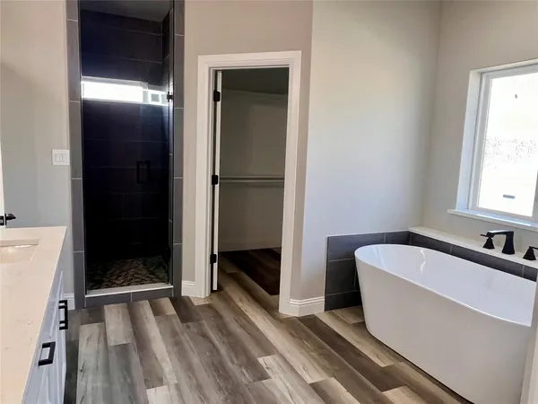 a bathroom with a bathtub and shower