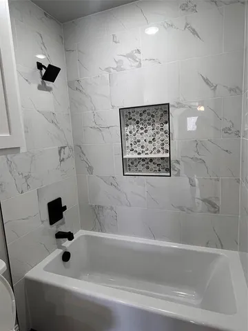 a bathroom with a bathtub and a shower