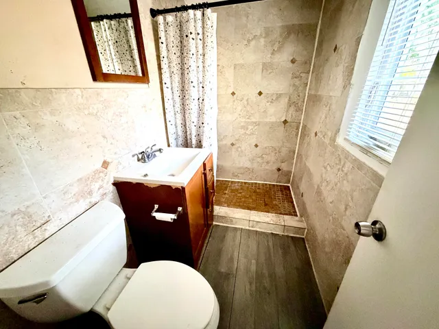 a bathroom with a sink toilet and shower