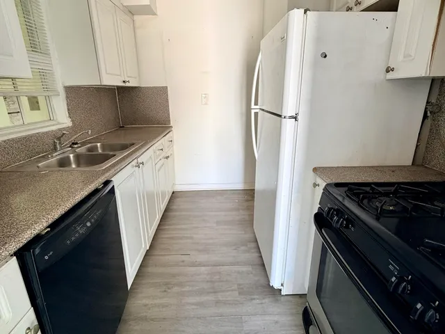 a kitchen with a refrigerator and a sink