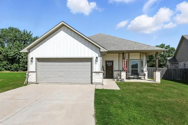 a front view of a house with a yard and porch