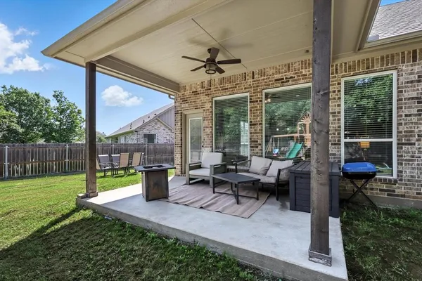 a view of a patio with a dining table and chairs