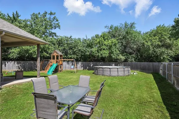 a view of a backyard with sitting area