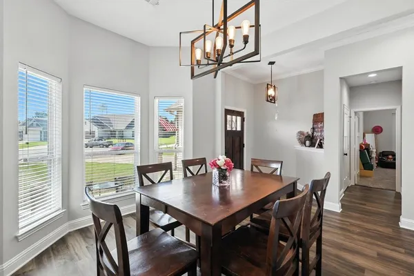 a view of a dining room with furniture and wooden floor