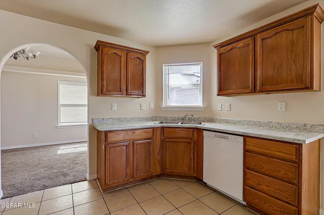 a view of a room with a chandelier fan