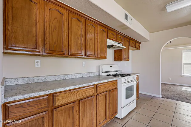 a view of a big room with windows and chandelier