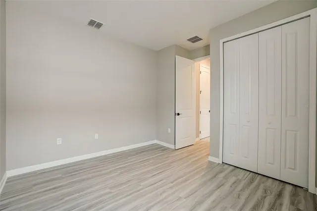 a view of an empty room and wooden floor