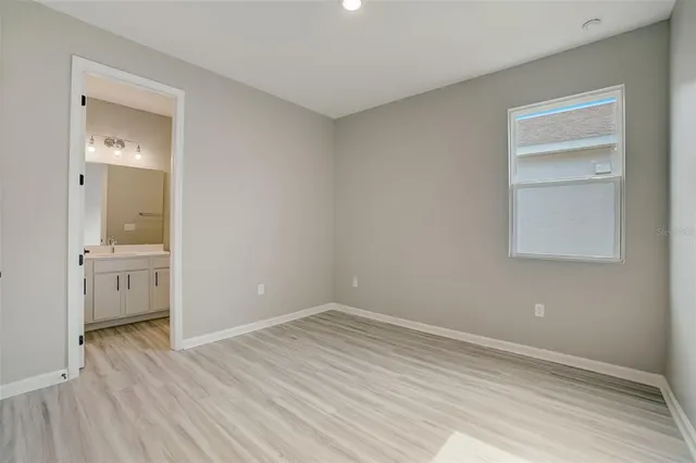 a view of room with window and wooden floor