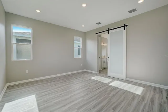 a bathroom with a sink double vanity granite tub and a mirror