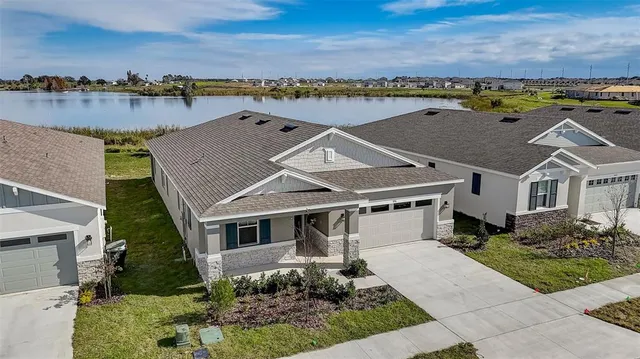 an aerial view of residential houses with outdoor space and ocean view