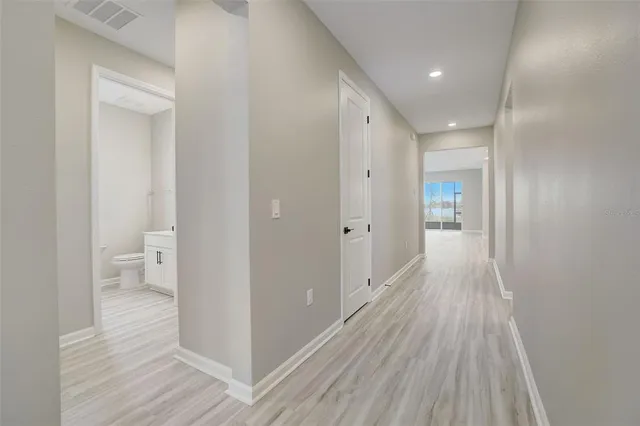 a view of a room with wooden floor and a toilet