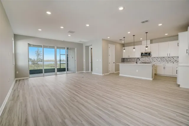 a view of kitchen with wooden floor and a window