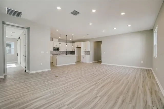 a view of kitchen with refrigerator microwave and stove