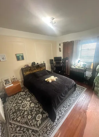 a bed sitting in a bedroom next to a window with dresser