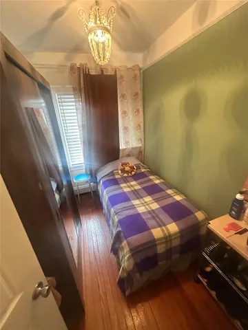 a bedroom with a bed and a mirror