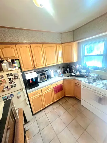 a kitchen with stainless steel appliances kitchen island granite countertop a sink a stove a counter top space and a window