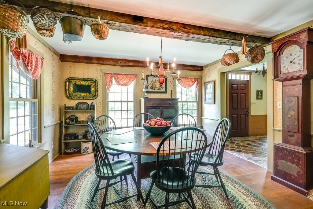 9699 Acme Road Rittman, OH 44270 - Photo 11 of 36 Dining room featuring hardwood / wood-style floors and an inviting chandelier