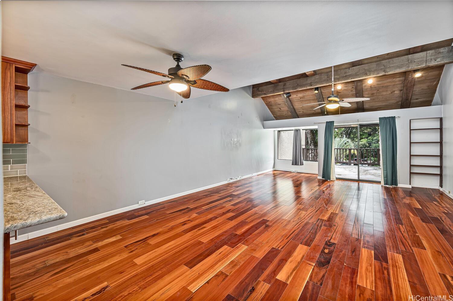 46-359 Haiku Road, Unit C2 Kaneohe, HI 96744 - Photo 1 of 1 a view of a livingroom with wooden floor and a ceiling fan