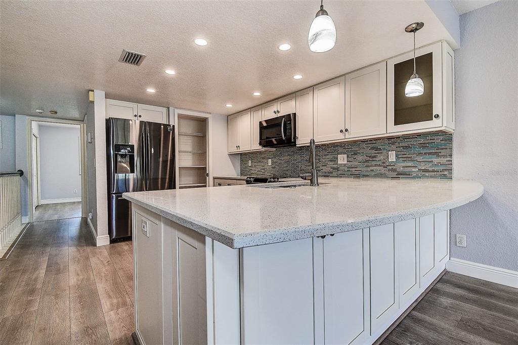 14865 Seminole Trail Seminole, FL 33776 - Photo 11 of 54 a kitchen with stainless steel appliances granite countertop a sink and a refrigerator