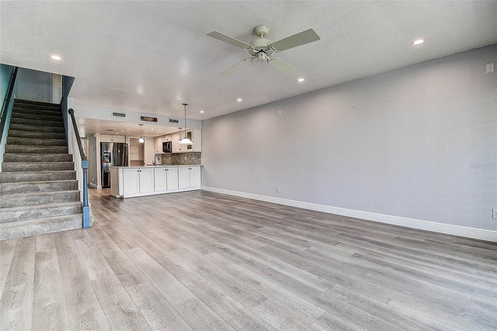 14865 Seminole Trail Seminole, FL 33776 - Photo 17 of 54 an empty room with wooden floor ceiling fan and windows