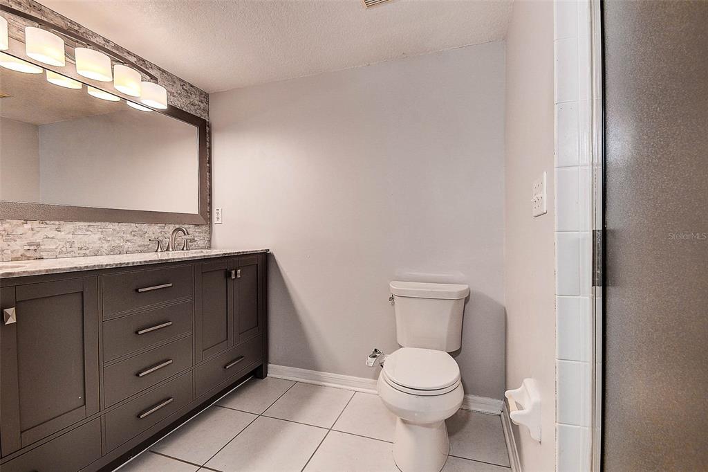 14865 Seminole Trail Seminole, FL 33776 - Photo 26 of 54 a bathroom with a toilet sink and mirror