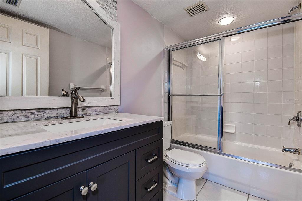 14865 Seminole Trail Seminole, FL 33776 - Photo 36 of 54 a bathroom with a sink a toilet and shower