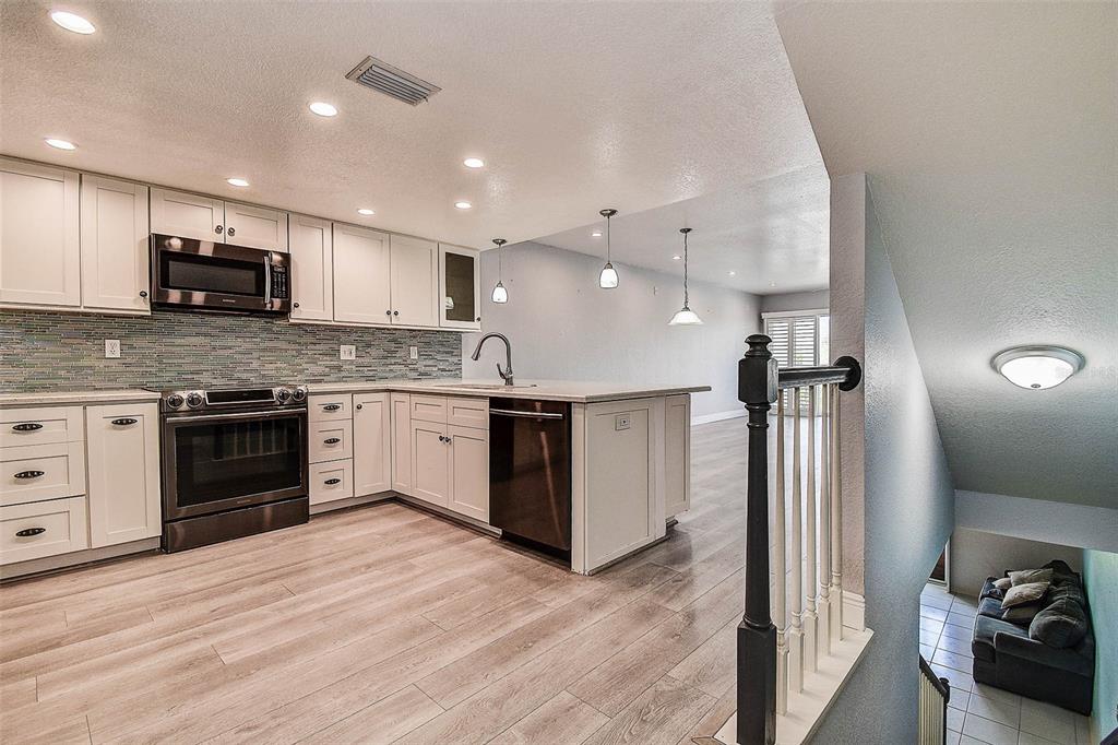 14865 Seminole Trail Seminole, FL 33776 - Photo 9 of 54 a large kitchen with stainless steel appliances granite countertop a stove and a sink