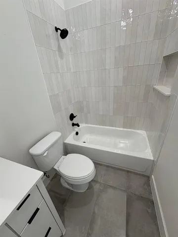a bath room with a toilet and a bath tub