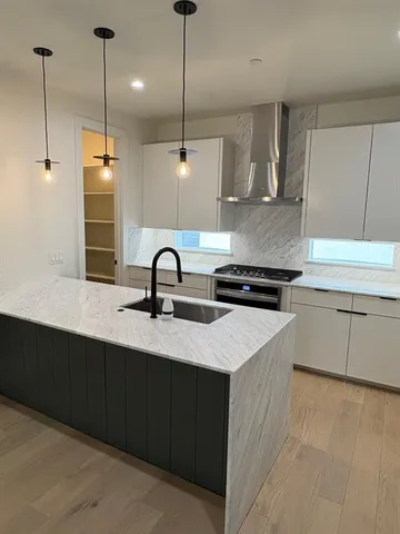 a kitchen with a sink a counter and cabinets