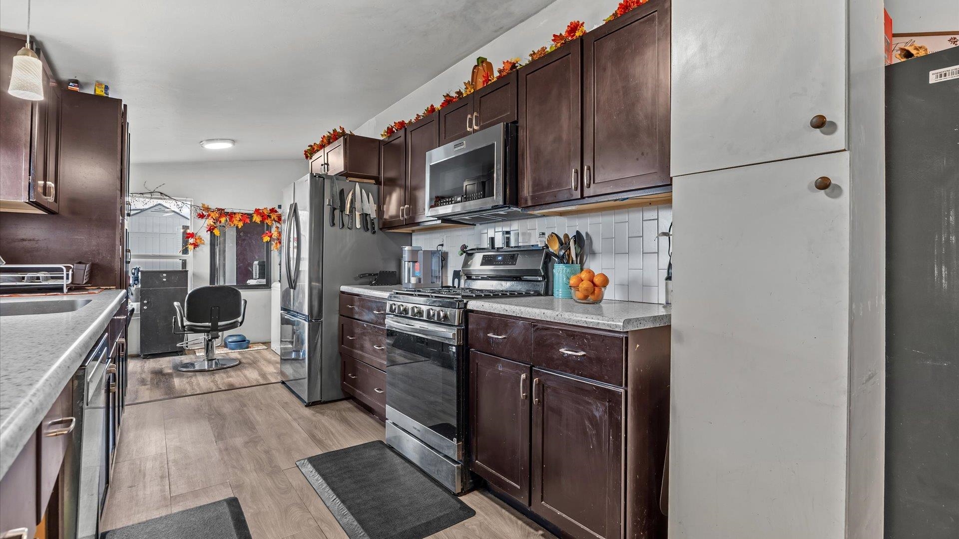 3216 E Road Clifton, CO 81520 - Photo 11 of 33 a kitchen with stainless steel appliances granite countertop a refrigerator stove and sink